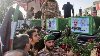 Para pelayat berdiri di samping peti mati komandan Garda Revolusi Iran Hossein Salami (R), dan komandan militer lainnya yang terbunuh dalam serangan Israel pada hari pertama perang, dalam prosesi pemakaman mereka di Teheran, Sabtu (28/6/2025). Foto: